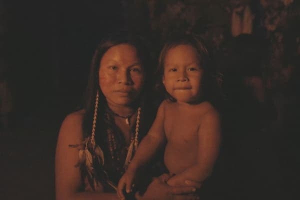 Local resident of the Tumbira community standing in the Amazon rainforest