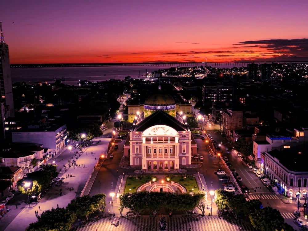 erial night view of the historic illuminated Amazon Theatre in downtown Manaus.