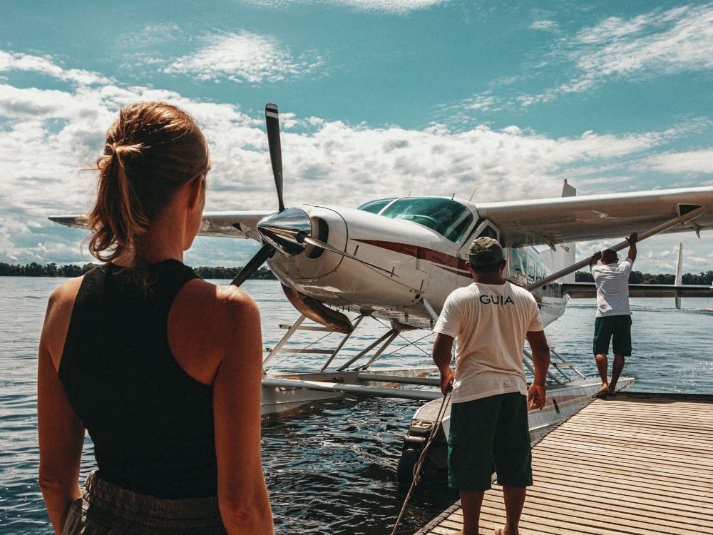 Seaplane docked at a river pier in Manaus, a common transport method to reach remote Amazon jungle lodges and explore nature.