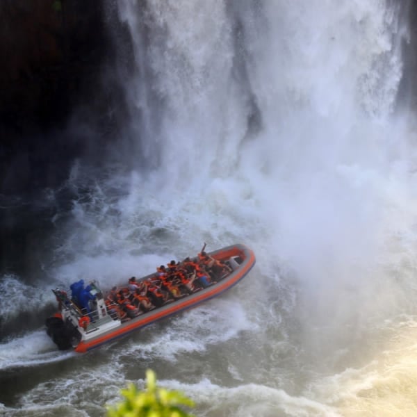 A Macuco Safari boat carrying visitors into the spray at the foot of Iguazu Falls, Brazil.