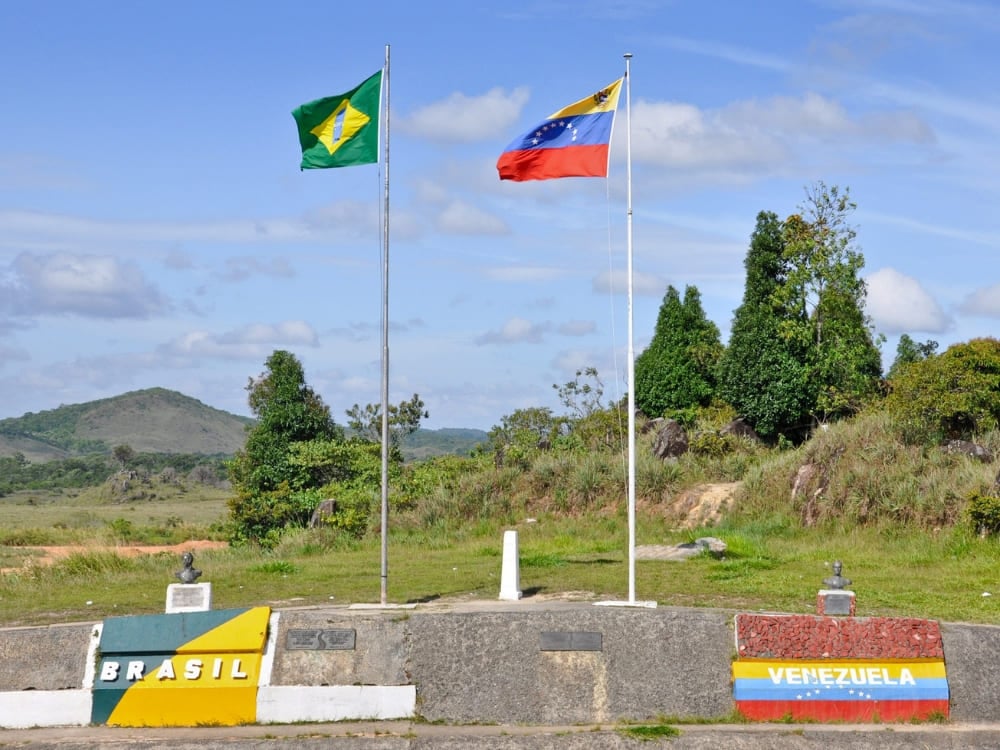 The Brazil–Venezuela border marker with both national flags, on the crossing used to reach Mount Roraima
