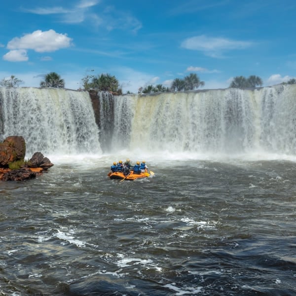 A rafting boat approaching the Cachoeira da Velha waterfall in Jalapão, Tocantins, Brazil.