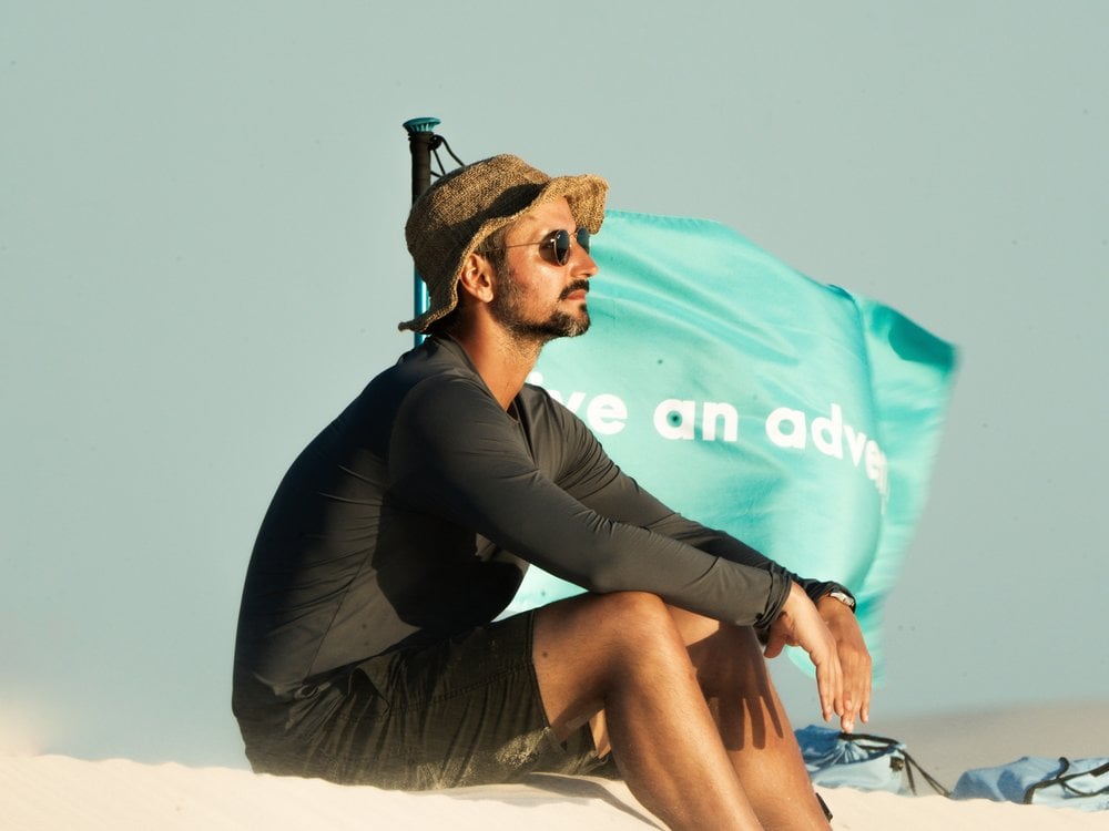 Portuguese traveler Diogo Melo resting on a dune in Lençóis Maranhenses
