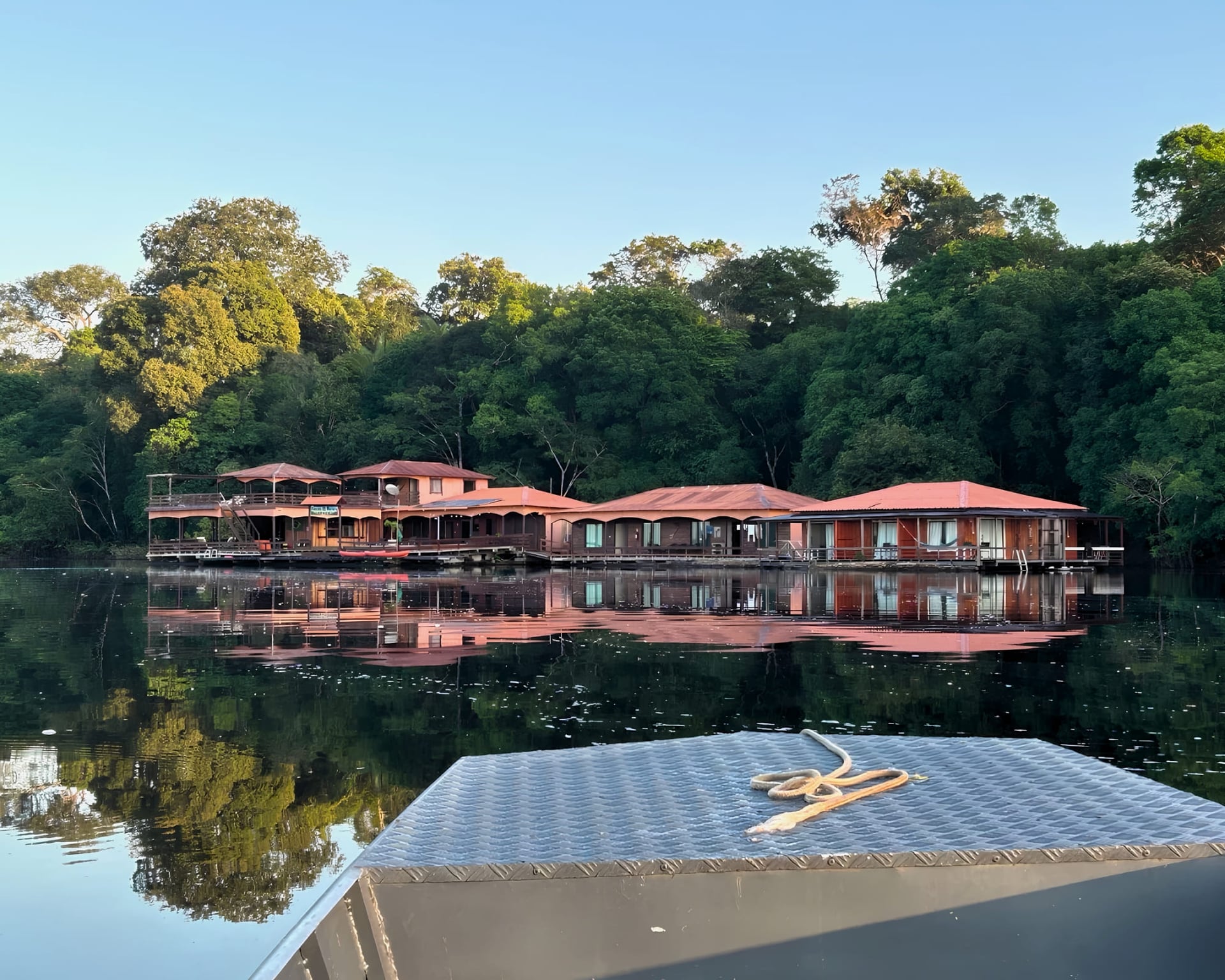 Amazon eco floating lodge on the Rio Negro seen from the boat at sunrise