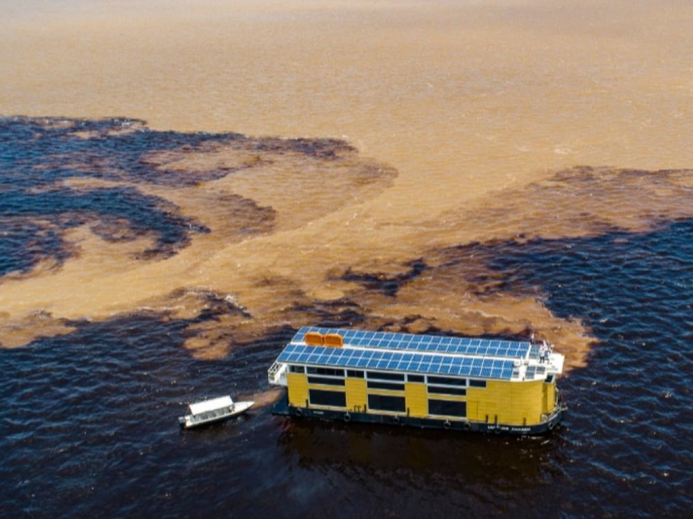 Aerial shot of the Untamed Amazon boat showing the solar panels on the roof, highlighting its eco-friendly energy system and sustainable design. Aerial shot of the Untamed Amazon boat showing the solar panels on the roof, highlighting its eco-friendly energy system and sustainable design.