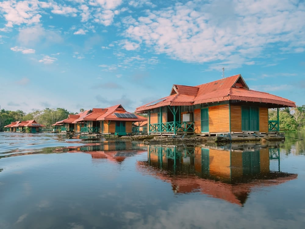 . The floating bungalows of Uakari Lodge sitting on the dark river waters, a unique destination for ecotourism in Brazil.
