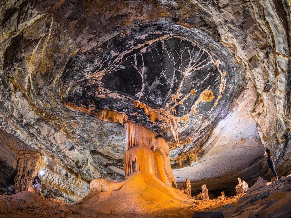 Interior of a cave with impressive geological formations, stalactites, and stalagmites under warm artificial lighting in Chapada Diamantina. Interior of a cave with impressive geological formations, stalactites, and stalagmites under warm artificial lighting in Chapada Diamantina.