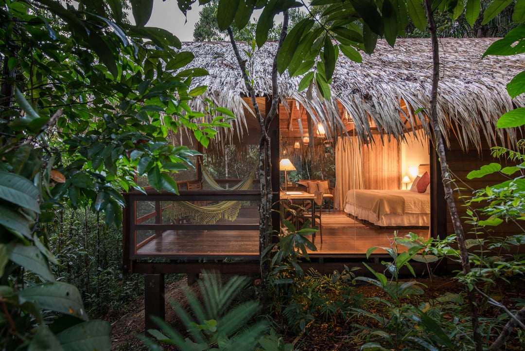 Comfortable Amazon jungle lodge with a thatched roof nestled in the tropical rainforest. Comfortable Amazon jungle lodge with a thatched roof nestled in the tropical rainforest.