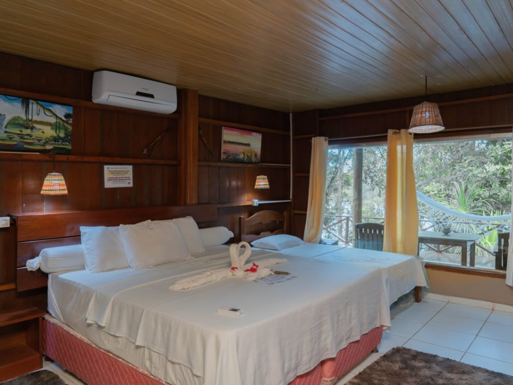 A comfortable and affordable bungalow bedroom with two beds at Amazon Turtle Lodge in Brazil. A comfortable and affordable bungalow bedroom with two beds at Amazon Turtle Lodge in Brazil.