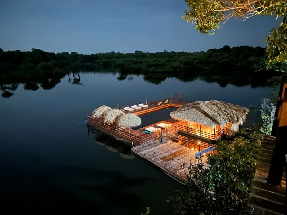 A floating deck and pool illuminated at night at Juma Amazon Lodge in the Amazon rainforest. A floating deck and pool illuminated at night at Juma Amazon Lodge in the Amazon rainforest.