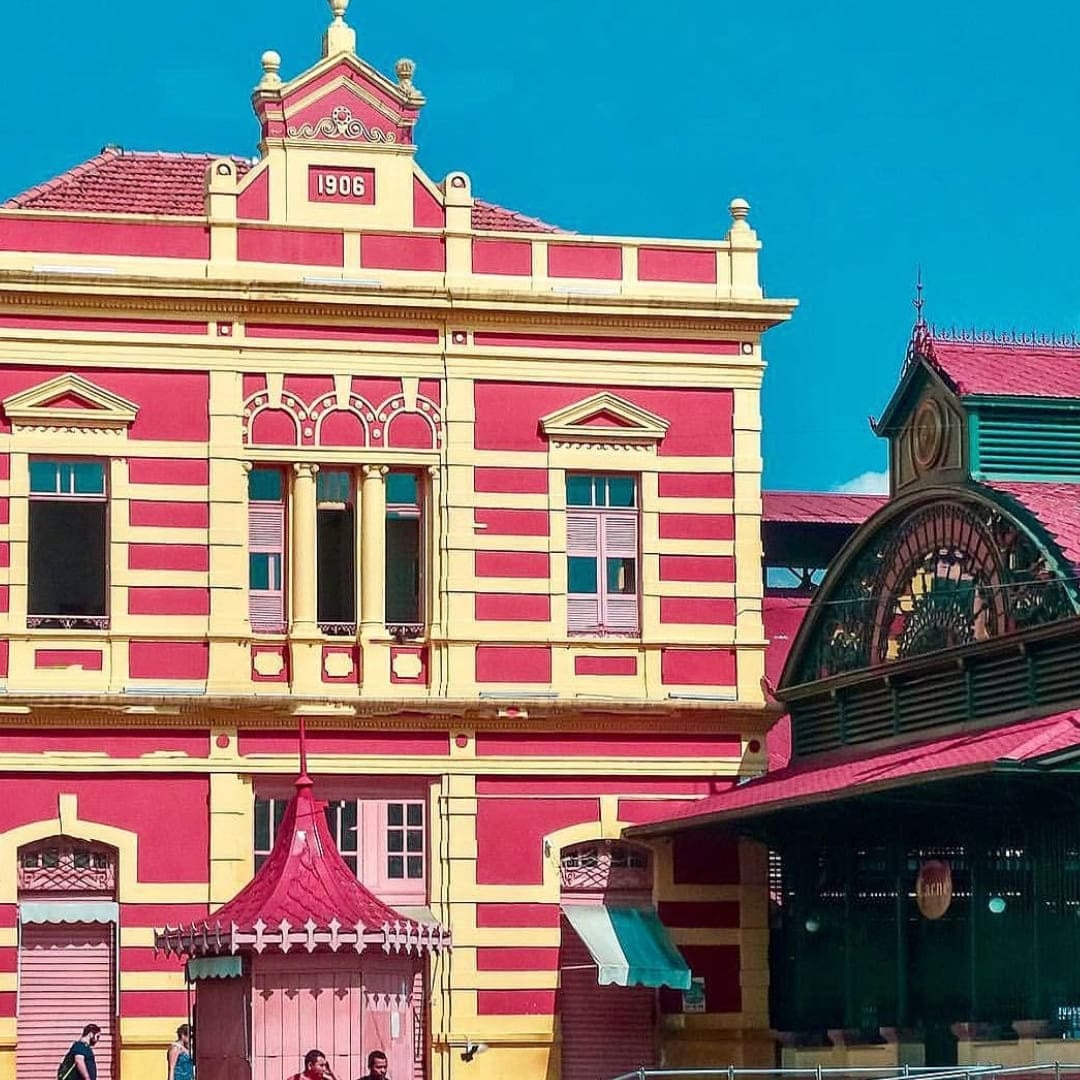 Historic red and pink colonial building facade in Manaus featuring architecture from the rubber boom era. Historic red and pink colonial building facade in Manaus featuring architecture from the rubber boom era.