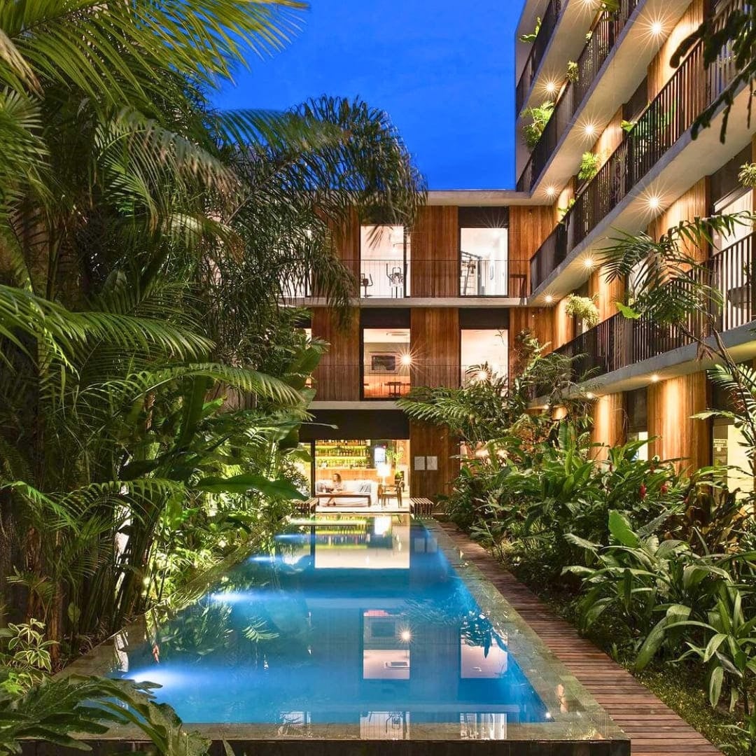 Outdoor swimming pool surrounded by tropical gardens and building balconies at Hotel Villa Amazonia. Outdoor swimming pool surrounded by tropical gardens and building balconies at Hotel Villa Amazonia.