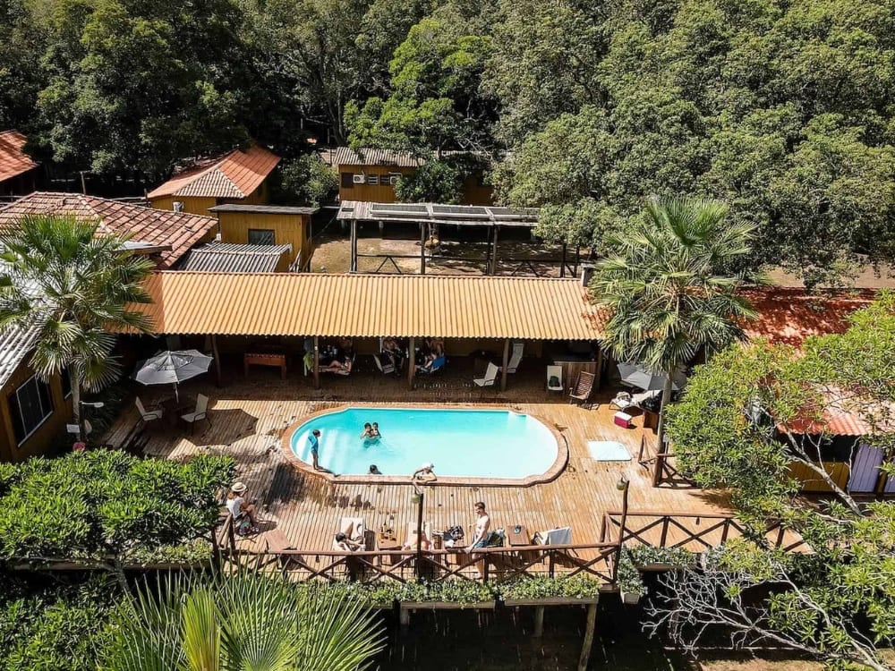 Guests swim in the outdoor pool on a wooden deck at the Pantanal Jungle Lodge near the Miranda River. Guests swim in the outdoor pool on a wooden deck at the Pantanal Jungle Lodge near the Miranda River.