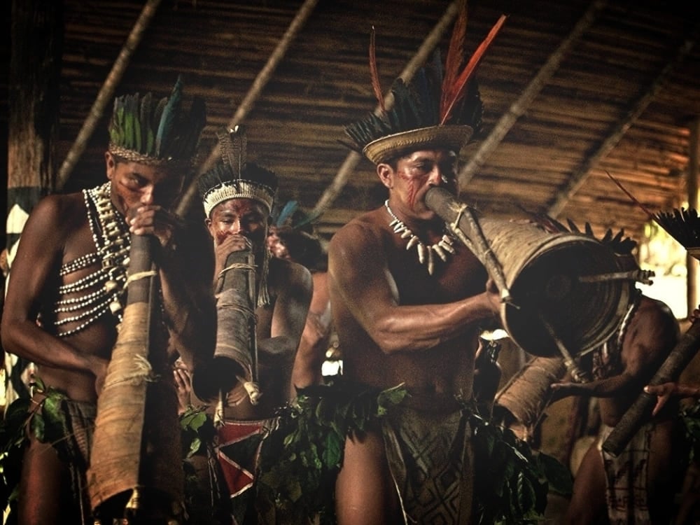 Indigenous men playing traditional wind instruments during a cultural ceremony in the Amazon. Indigenous men playing traditional wind instruments during a cultural ceremony in the Amazon.
