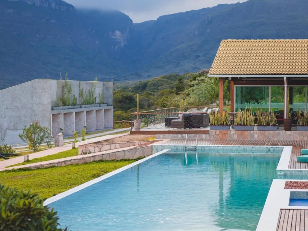Modern swimming pool and sophisticated concrete architecture of Pousada Amanhecer overlooking the mountains in Vale do Capão. Modern swimming pool and sophisticated concrete architecture of Pousada Amanhecer overlooking the mountains in Vale do Capão.
