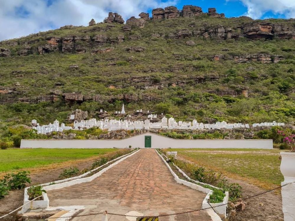 Bright white tombstones of the historic Bizantino Cemetery built into the rocky green mountainside of Mucugê. Bright white tombstones of the historic Bizantino Cemetery built into the rocky green mountainside of Mucugê.