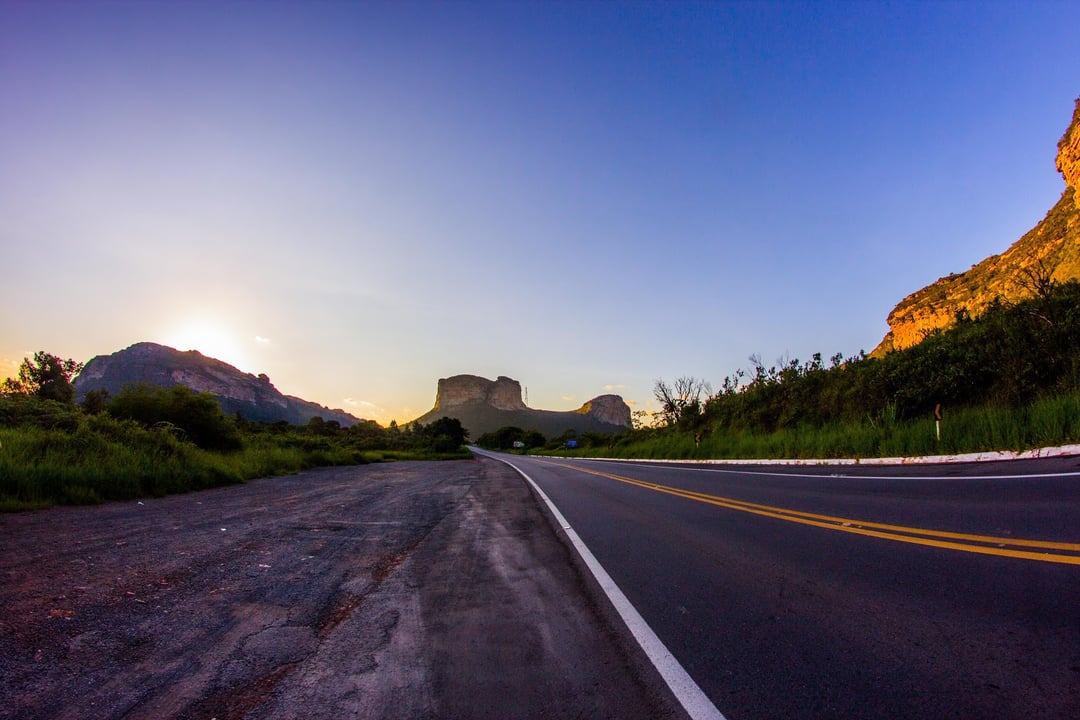 Empty paved highway leading towards the mountains of Chapada Diamantina Bahia at sunrise. Empty paved highway leading towards the mountains of Chapada Diamantina Bahia at sunrise.