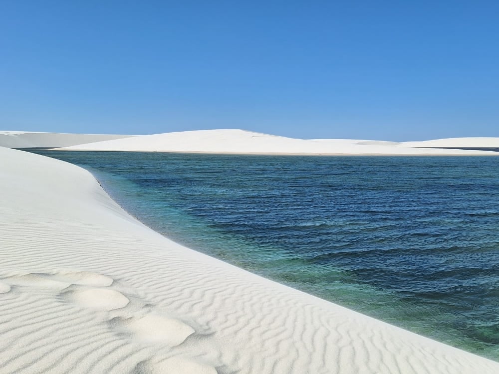 Turquoise freshwater lagoons nestled between vast white sand dunes in Lençóis Maranhenses National Park. Turquoise freshwater lagoons nestled between vast white sand dunes in Lençóis Maranhenses National Park.