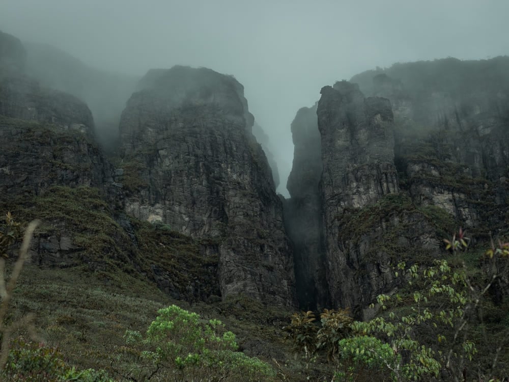 The dark, rocky cliffs of Pico da Neblina, Brazil's highest peak, shrouded in mist within the Amazon Rainforest. The dark, rocky cliffs of Pico da Neblina, Brazil's highest peak, shrouded in mist within the Amazon Rainforest.