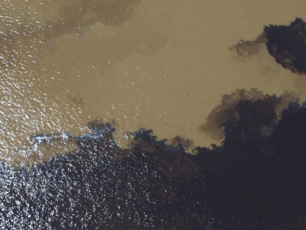 The dark waters of the Rio Negro and the sandy waters of the Rio Solimões flow side by side without mixing during an Amazon boat tour. The dark waters of the Rio Negro and the sandy waters of the Rio Solimões flow side by side without mixing during an Amazon boat tour.