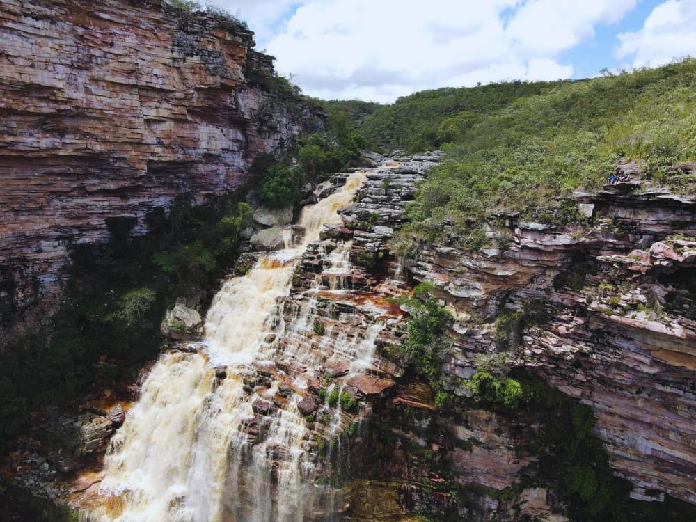 The 230-meter Encantada Waterfall plunges over flat, terraced rocky ledges into a deep canyon near Itaetê. The 230-meter Encantada Waterfall plunges over flat, terraced rocky ledges into a deep canyon near Itaetê.