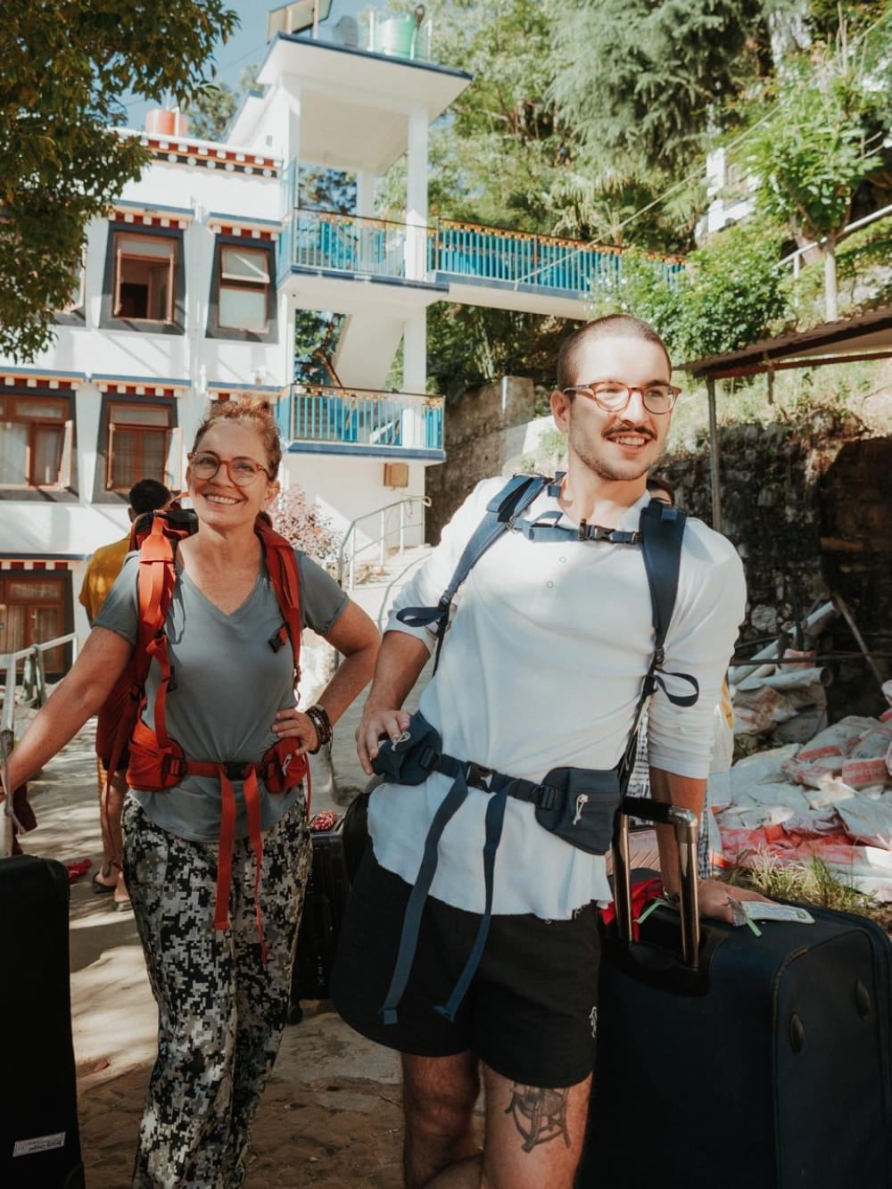 Mila and Lorenzo wearing trekking backpacks and smiling as they prepare for physical endurance on the Mardi Himal trek in Nepal. Mila and Lorenzo wearing trekking backpacks and smiling as they prepare for physical endurance on the Mardi Himal trek in Nepal.