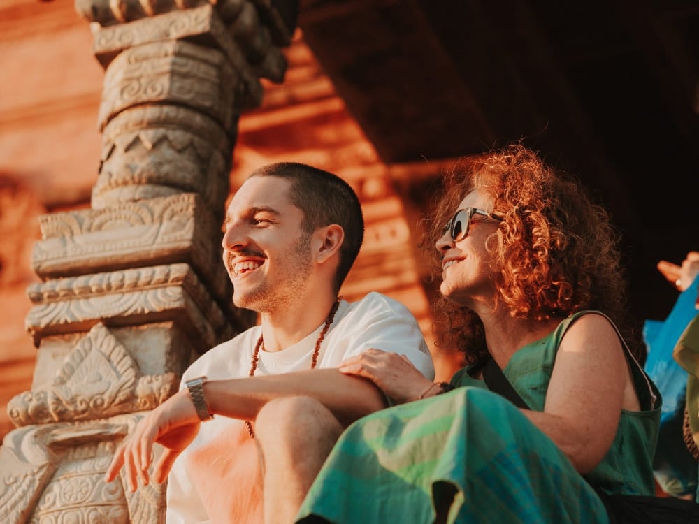 Mila Ricetti and her son Lorenzo smiling and sitting together at a historic brick temple during their ecotourism expedition in Nepal. Mila Ricetti and her son Lorenzo smiling and sitting together at a historic brick temple during their ecotourism expedition in Nepal.