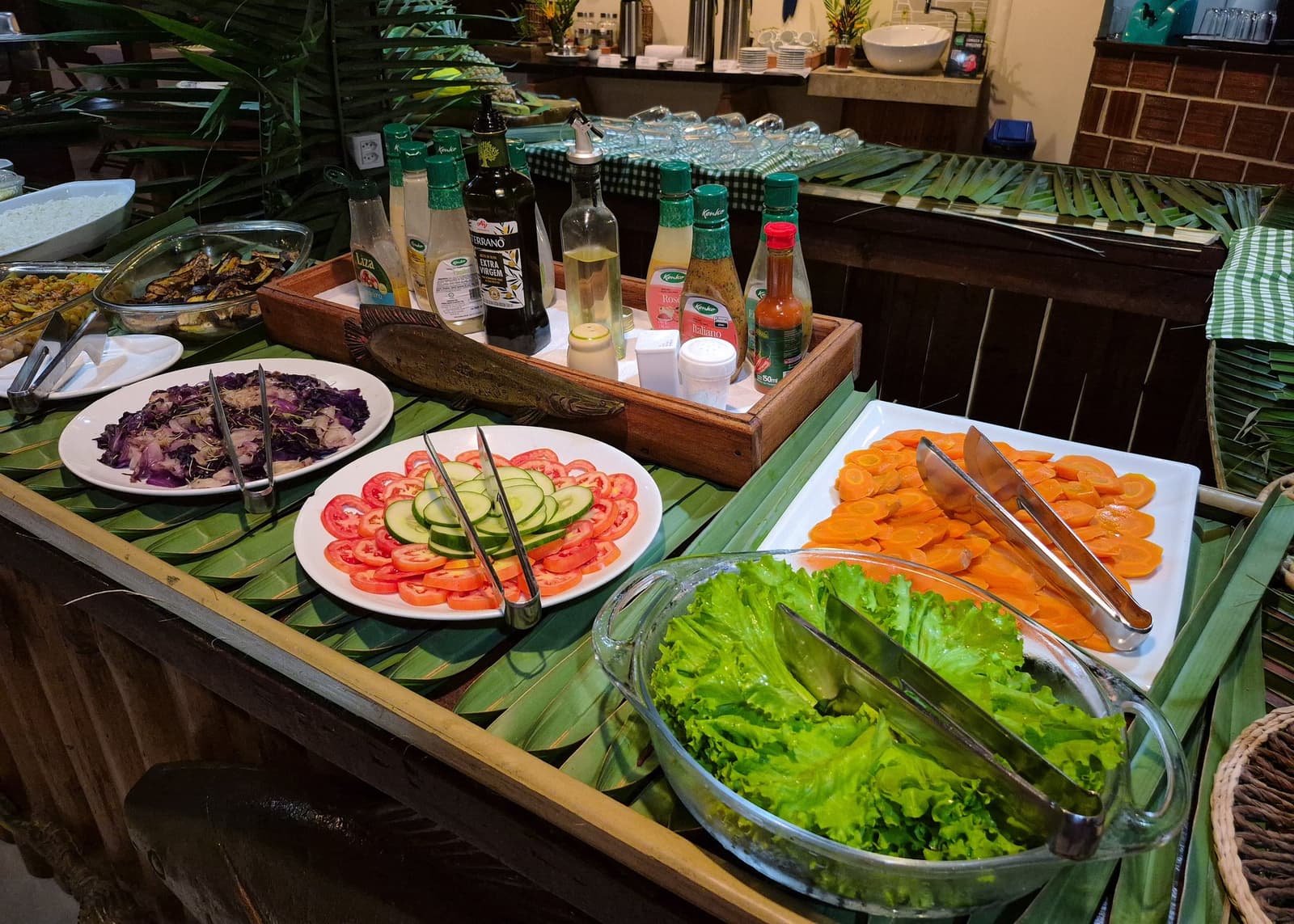 Eating well in the jungle is easier than you'd think. A colourful salad buffet at the Amazon Turtle Lodge, with plates of sliced tomatoes, cucumber, carrots, red cabbage, and crisp lettuce arranged on banana leaves alongside dressings and olive oil