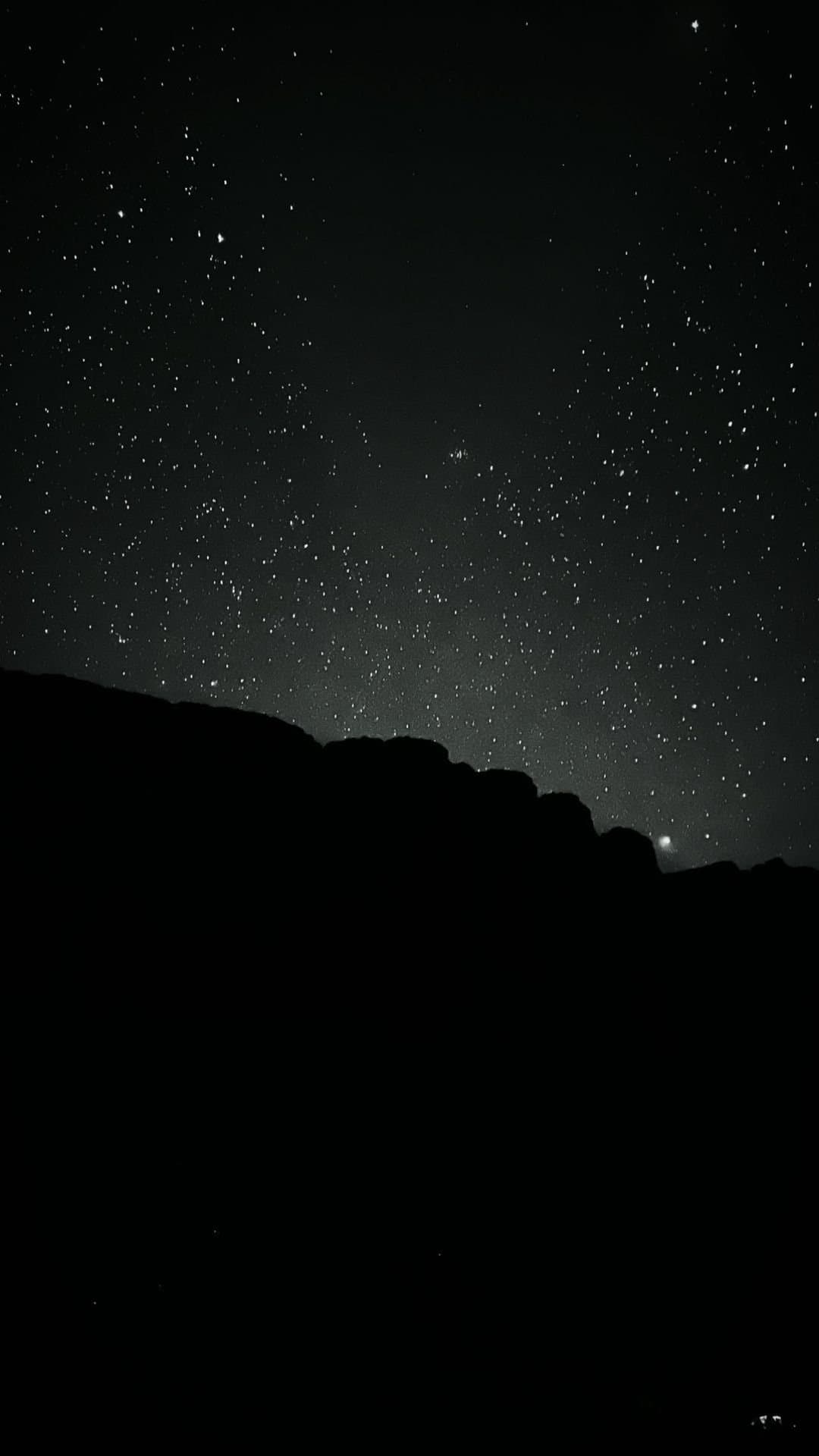 Up here, the stars don't need a filter. A dense field of stars fills the night sky above the dark silhouette of a rocky ridgeline on the Mount Roraima trek