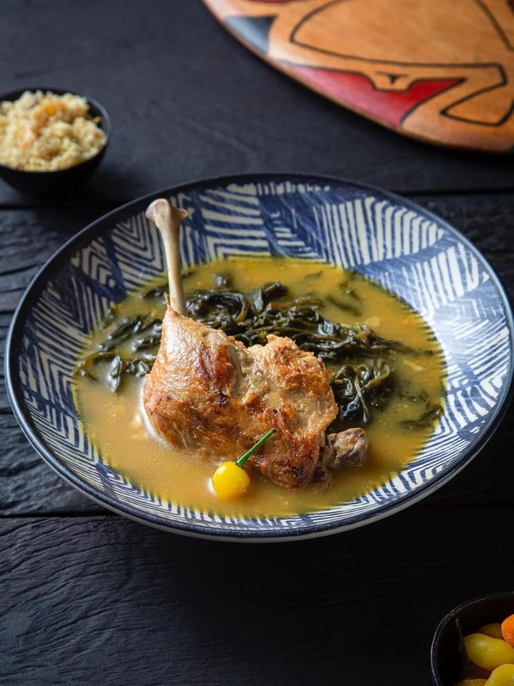 @combu_da_amazonia Pato no tucupi: a golden duck leg in yellow tucupi broth with jambu leaves, served with rice